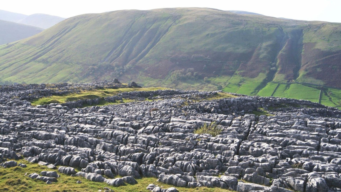 View west to Harter Fell from the impressive limestone pavements at Stennerskeugh Clouds